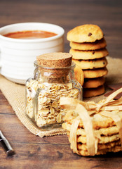 Cookies and a jar of oats with a cup of coffee