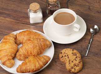 Some pastries and a cup of coffee with milk
