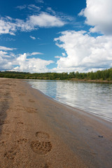 Sandy beach with footprint and forest in Ivalo
