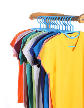 t-shirts hanging on hangers