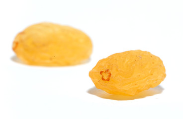 Golden raisins on a white background