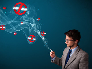 Attractive man smoking dangerous cigarette with no smoking signs