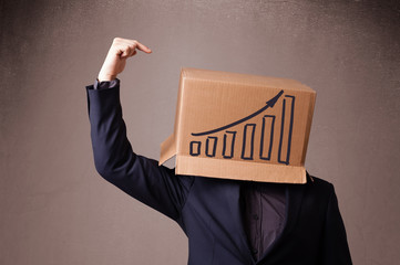 Young man gesturing with a cardboard box on his head with diagra