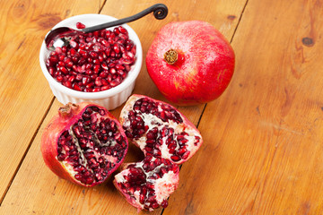 Pomegranate fruit and pips in a white bowl