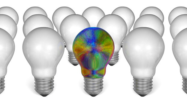 One multicolored iridescent light bulb among white ones