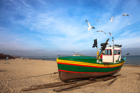 Fototapeta Fishing boat on the beach in Sopot, Poland.