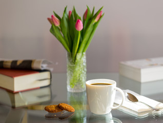 Black coffee in white mug glass topped table