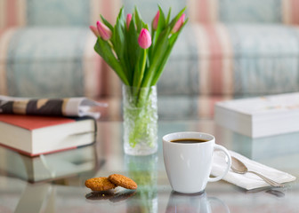 Black coffee in white mug glass topped table