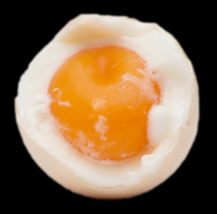 egg with yolk on black background
