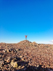 Girl standing on top of a hill