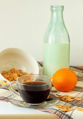 Breakfast cereal, milk and a cup of coffee