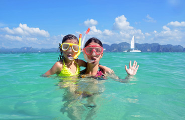 Happy mother and kid snorkeling in tropical sea, family vacation