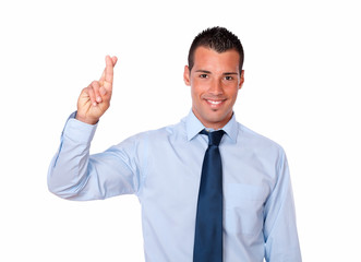 Cute young businessman with luck gesture