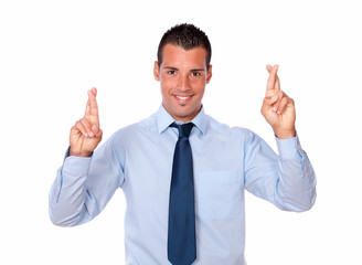 Attractive young businessman crossing his fingers