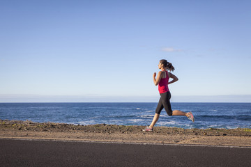 Young woman jogging along the seacoast