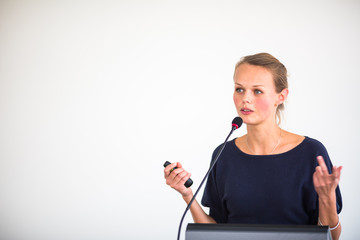 Pretty, young business woman giving a presentation