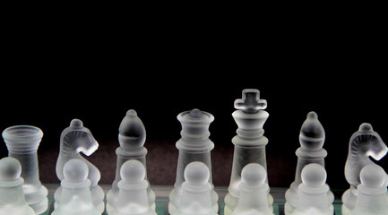 Glass chess on black background