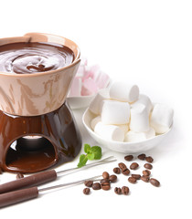 Chocolate fondue with marshmallow candies, isolated on white