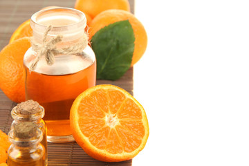 Tangerine essential oil and tangerines, isolated on white