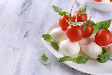Tasty mozzarella cheese with basil and tomatoes