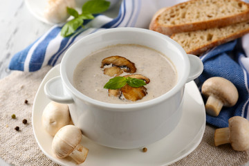 Mushroom soup in white pots, on napkin,  on wooden background