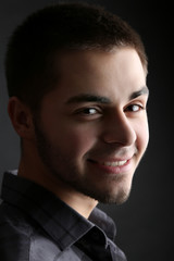 Handsome young man on dark background