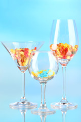 Goblets with pills on blue background