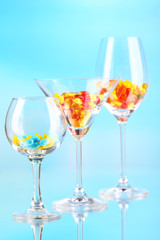 Goblets with pills on blue background