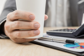 Fototapeta premium Businessman's hand showing financial report