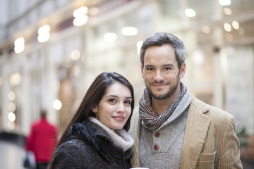 portrait of handsome couple city lights in the background