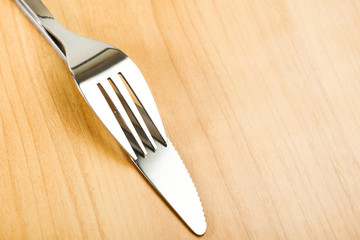 Knife and fork on wooden table