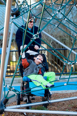 Father with disabled boy at the playground