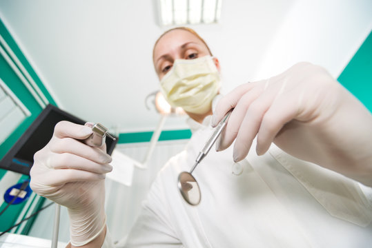 Dentist working from perspective of patient.