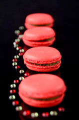 Four pink macaroons with coulis drops