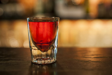 A glass of vodka on the bar, shallow DOF.