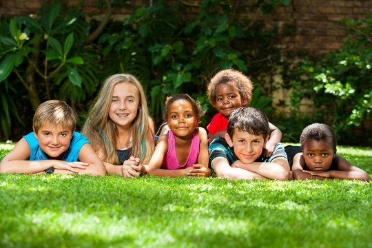 Diverse group of kids together in garden.
