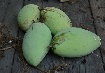 green mangoes  on wood