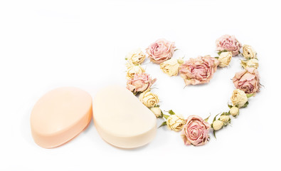 two bars of soap and a small rose in the form of heart