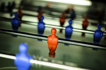 A figure of a table football player in the red colour on the toy