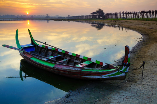 Wooden boat in Ubein Bridge at sunrise, Mandalay, Myanmar