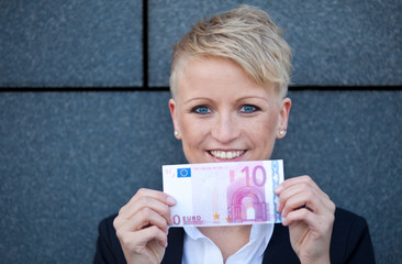 Attractive businesswoman holding 10 Euro