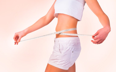 Diet concept. Woman measuring her waist, isolated 
