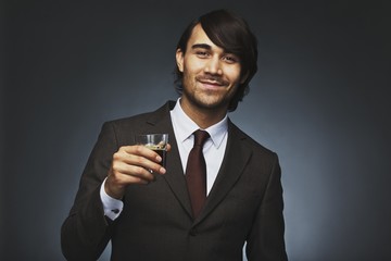 Successful young businessman having black coffee