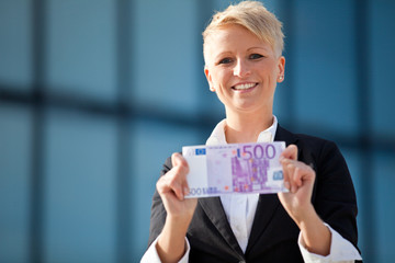 Attractive businesswoman holding 500 euro