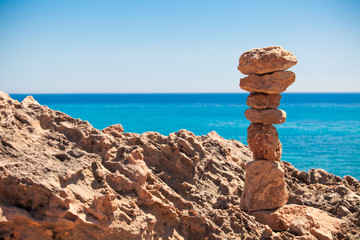Fototapeta na wymiar stack of stones on the beach and sea background. Set stones to r