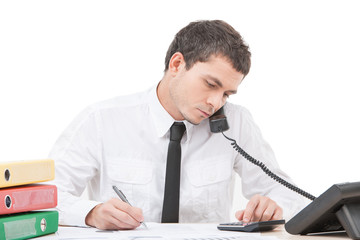 Fototapeta premium hardworking young man talking on phone.