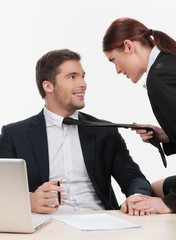 beautiful woman pulling man by tie.