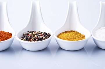 Various spices and herbs on white background