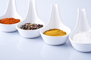 Various spices and herbs on white background