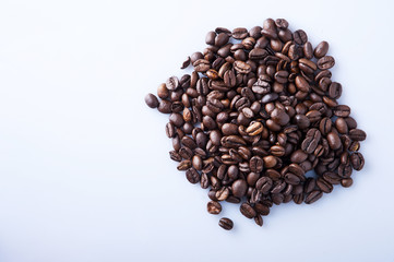 Roasted coffee beans pile from top on white background